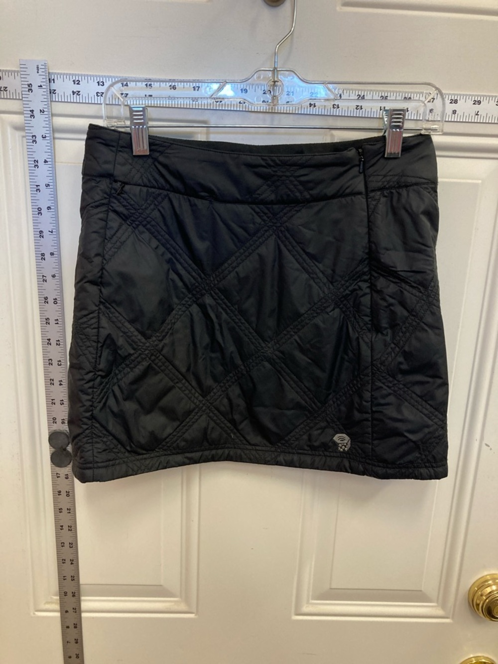 Quilted Mini Skirt, diamond stitch pattern, district logo at hem, side zipper